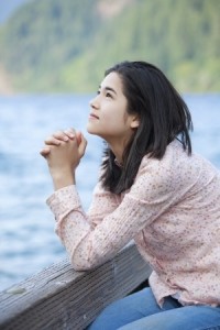 16057954_s Girl praying by lake